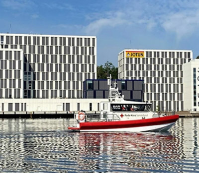 Boat on water near office buildings.