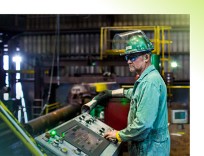A person in a green jumpsuit and safety gear