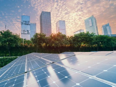 Solar panels in front of a city.