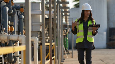A person wearing a safety vest and a hard hat