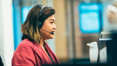 A woman wearing a headset.