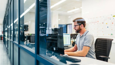 Man working at a computer in an office.