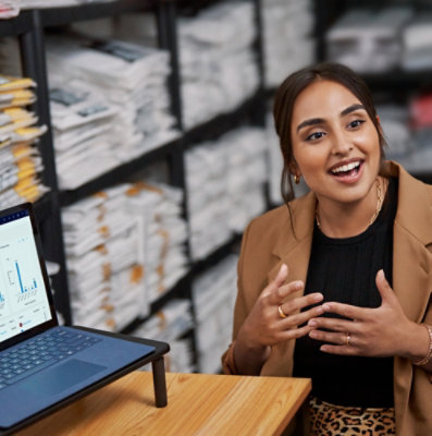 A women talking next to a laptop