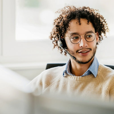 A person smiling while working at a desk