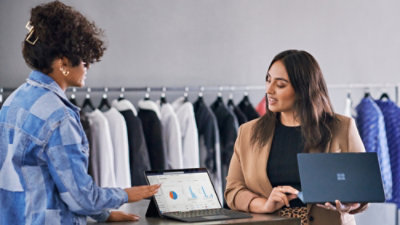 Two women are working on a laptop.