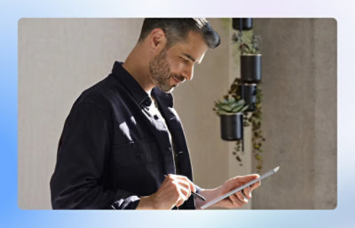 Person using a stylus on a tablet in a well-lit indoor space.