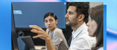 Team discussing work while looking at a monitor.