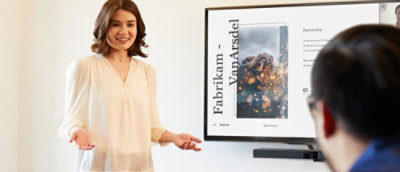 A person standing in front of a screen