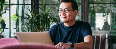 A person in glasses looking at a computer