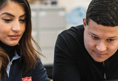 Two people working together and looking at a shared task.