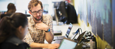 A person sitting at a desk with a computer