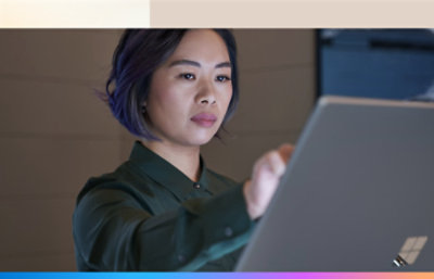 A woman working on surface pro using her hand