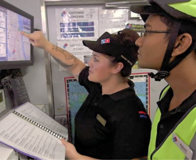 A man and woman looking at a computer screen.