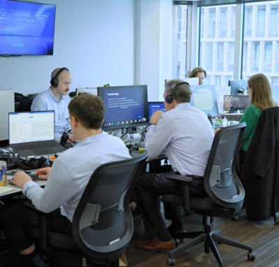 Multiple people working on computers in an office setting