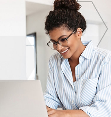 A woman working on the laptop and smiling
