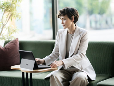 A woman sitting at a table using a laptop.