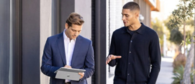 Two men looking at the laptop and discussing