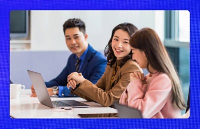 Three poeple smiling and discussing