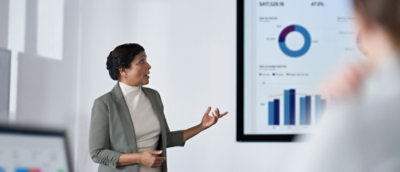 Woman explaining while looking at the graphs