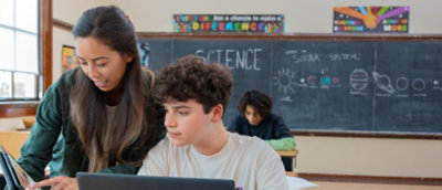 A child looking at a computer.