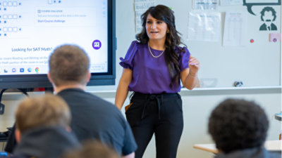 A person standing in front of a whiteboard.