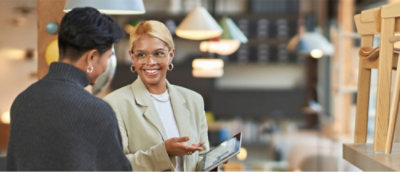 A person in a suit holding a tablet