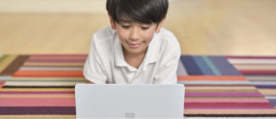 A child looking at a computer.
