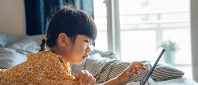 A child looking at tablet.