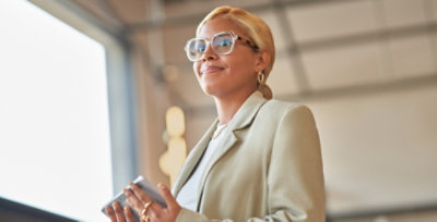 A woman wearing glasses looking at the screen