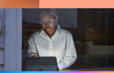 A woman using a tablet in front of a window.