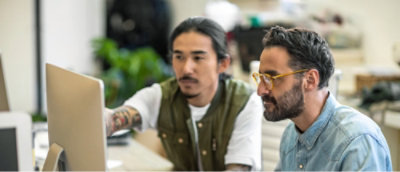 Група чоловіків дивиться на екран комп’ютера