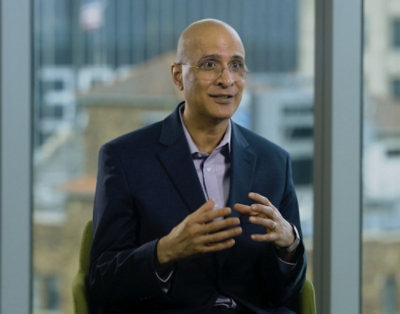 A person in a suit explaning something