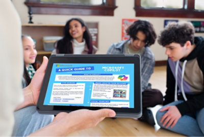 A group of people sitting at a table looking at a computer