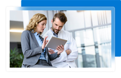 A man and woman looking at a tablet.