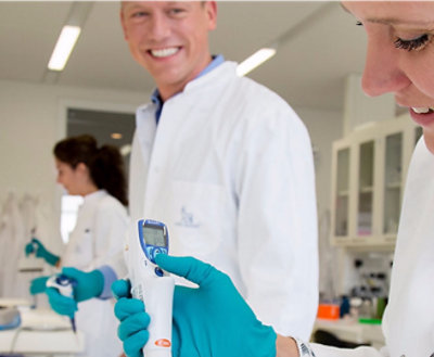A doctor holding a digital thermometer.
