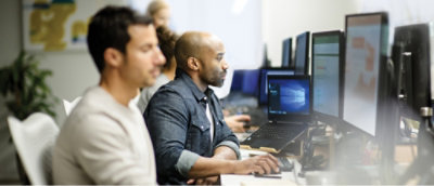 A man sitting at a desk with a laptop.