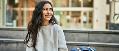 A woman smiling sitting outside