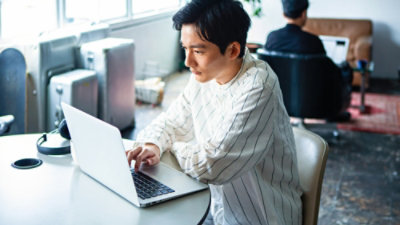 A man working with laptop in a office room