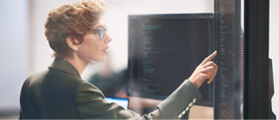 A Professional checking something in a desktop having some code