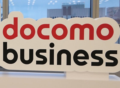 A close-up image of a Docomo sign with red and white letters.