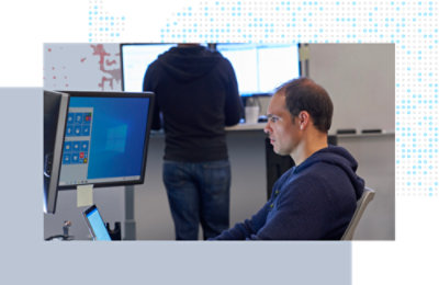 Person using a desktop computer at a workstation.