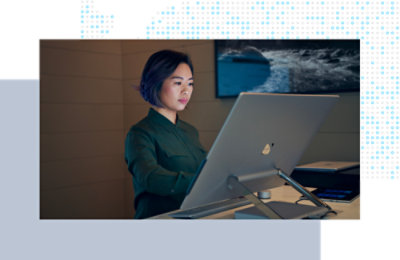 Person working at a desktop computer in a modern office.