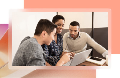 A group of people looking at a laptop.
