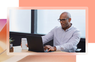 A person sitting at a table using a laptop.