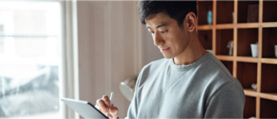 Ein Mann, der ein Tablet und einen Stift hält.