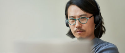 A man wearing glasses and headphones.