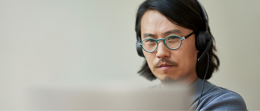 A man wearing glasses and headphones.
