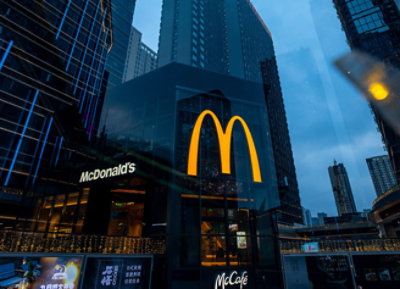 A McDonald's restaurant in a city with logos visible.