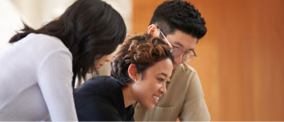 A group of people looking at a computer.