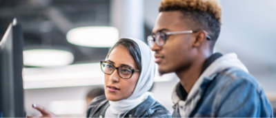 A woman wearing glasses and a white scarf.